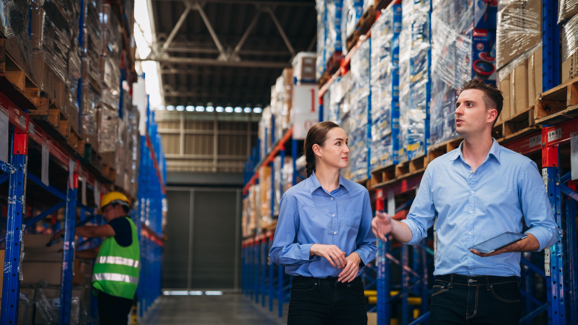 Warehouse worker working and checking the stock in the warehouse. 
Factory manager using digital tablet check barcode in industry factory logistic.